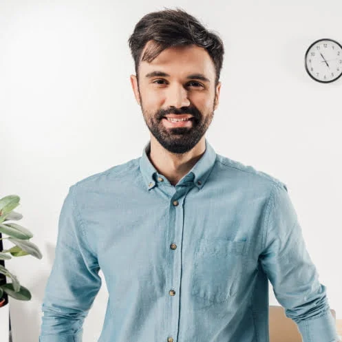 A man standing in front of a desk.