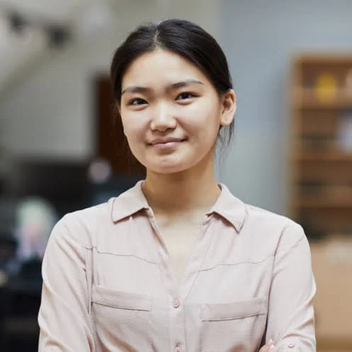 A young asian woman standing in an office.