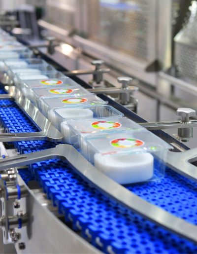 A blue cup conveyor belt in a factory for manufacturing industries.